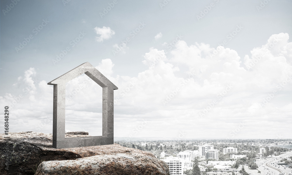 Conceptual image of concrete home sign on hill and natural lands