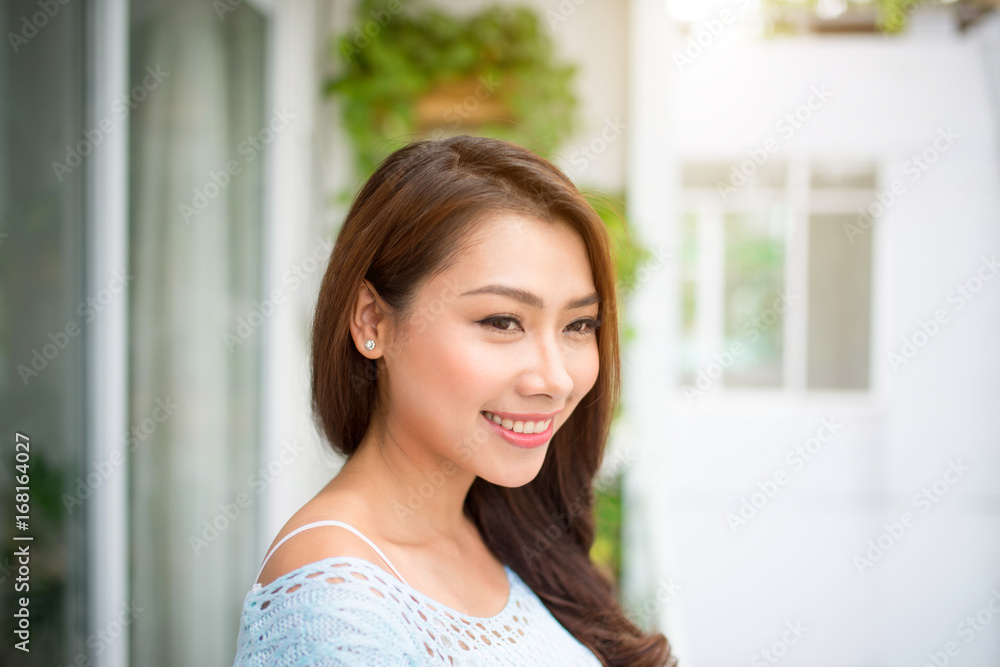 Carefree. Woman relaxing on balcony at home