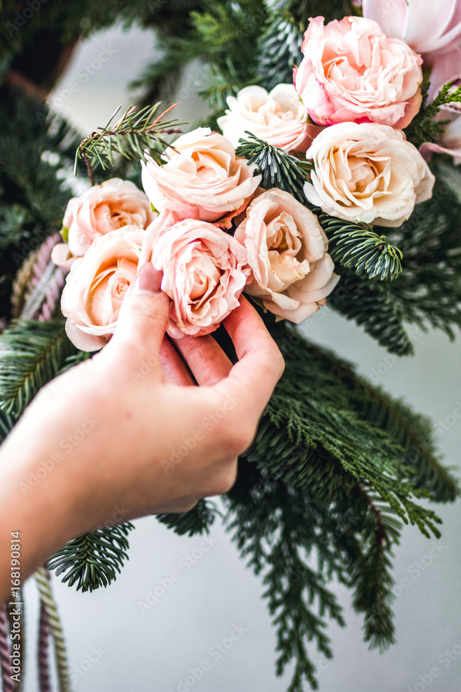 Florist makes Christmas wreath in workshop