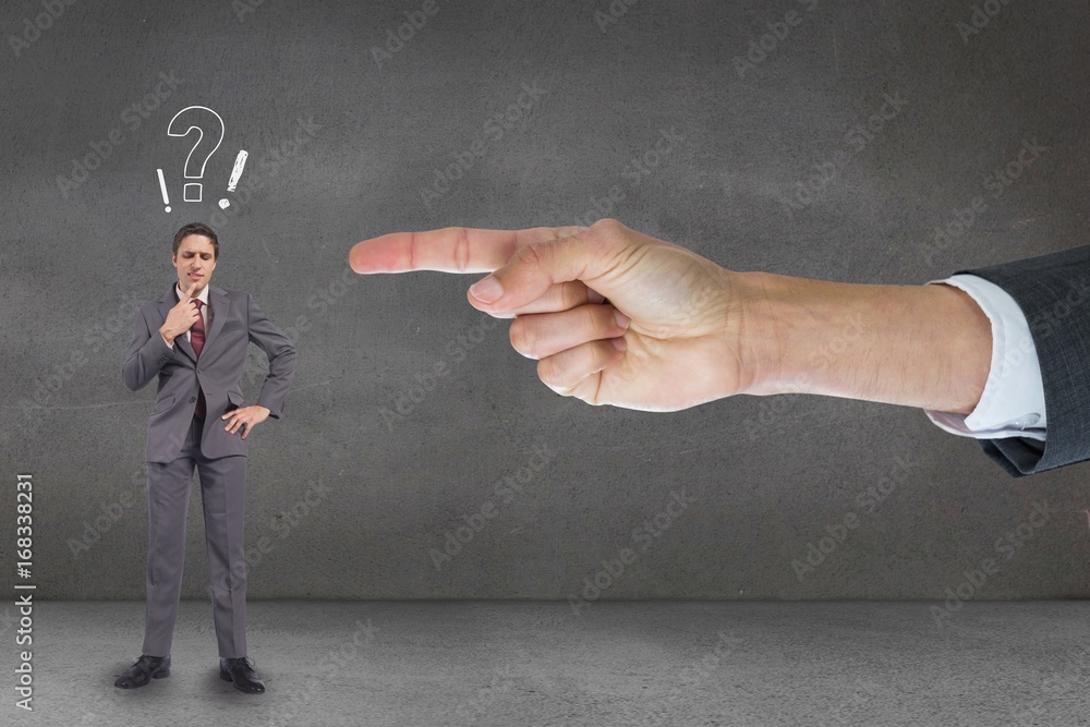 Hand pointing at business man against grey background with quest