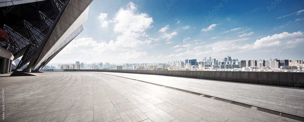 empty floor and cityscape of modern city against cloud sky