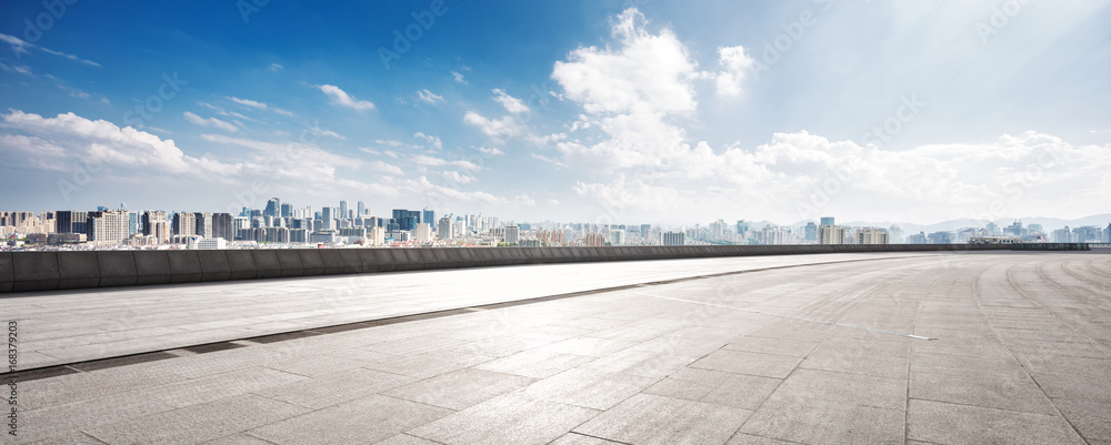 empty floor and cityscape of modern city against cloud sky