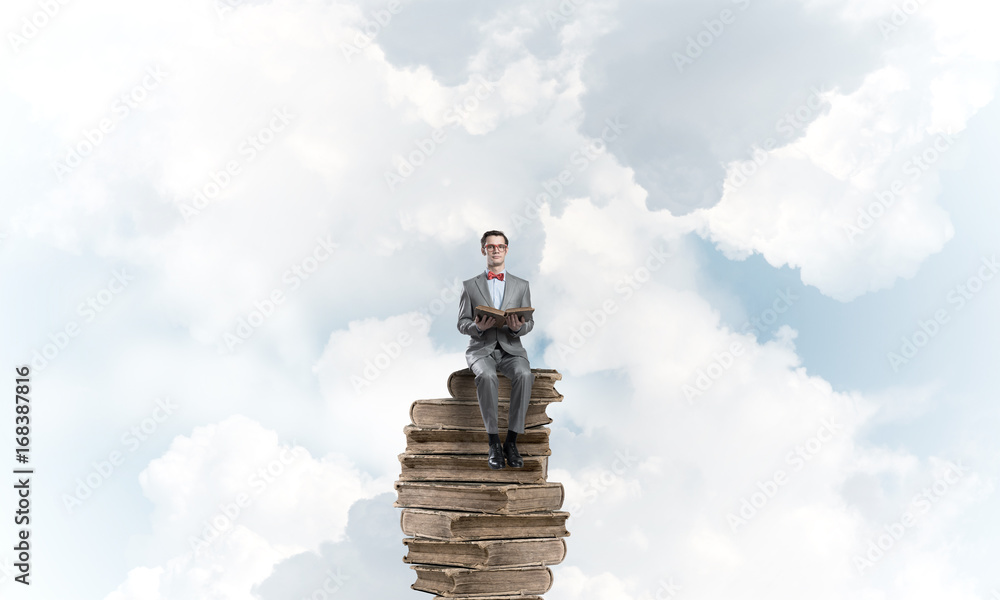 Young businessman or student floating in blue sky and studying the science