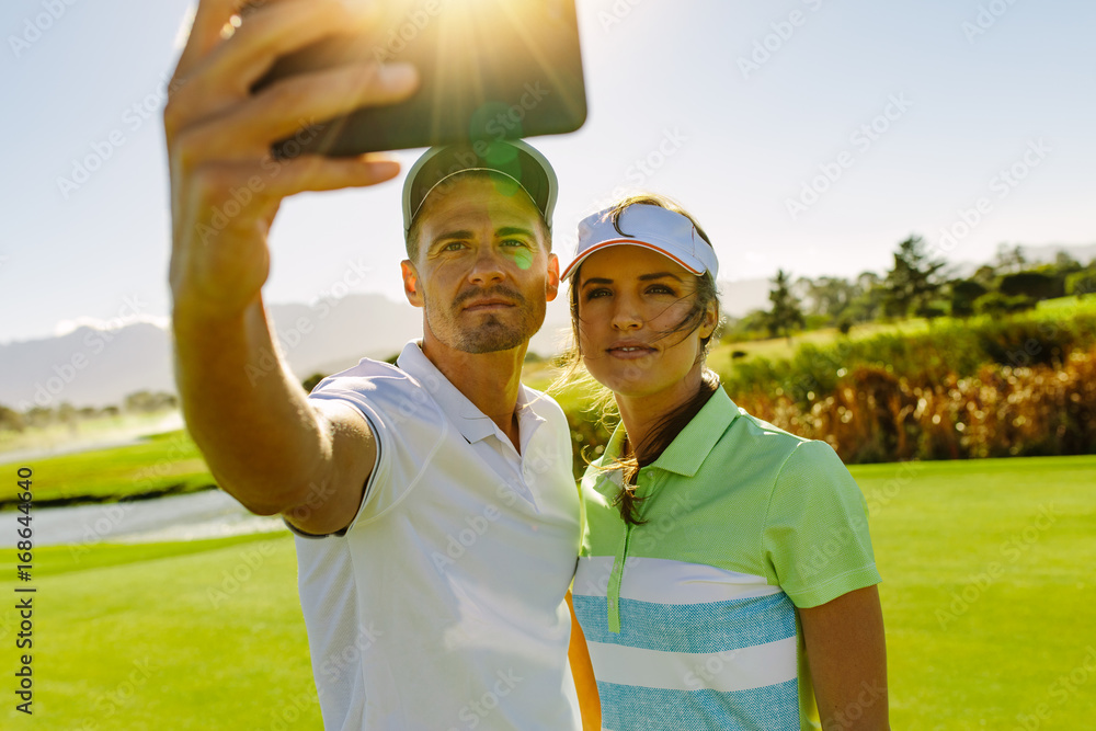 Golfers taking selfie with mobile phone