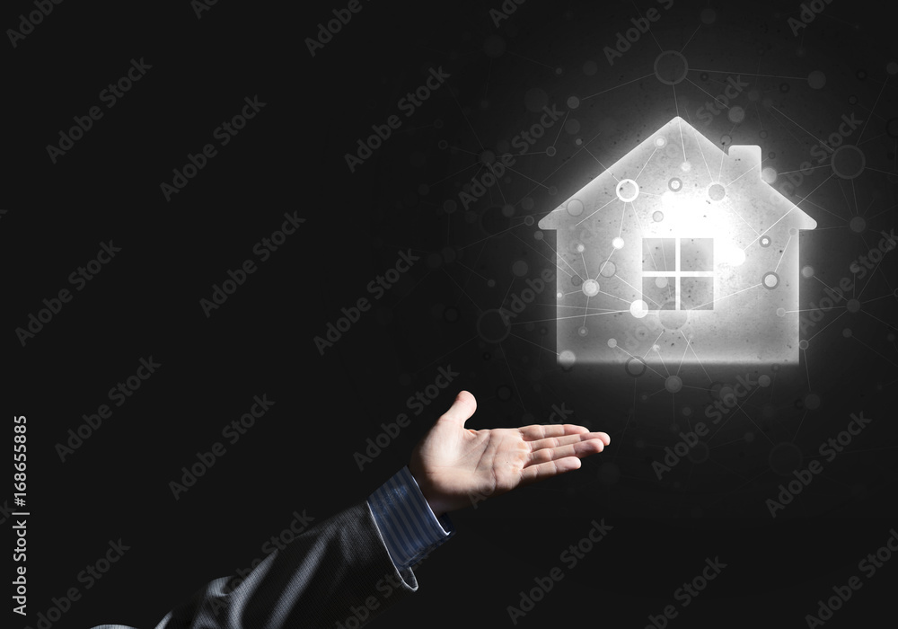 Conceptual image with hand pointing at house or main page icon on dark background