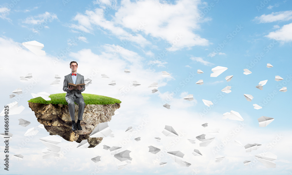 Young businessman or student studying the science and paper planes fly around