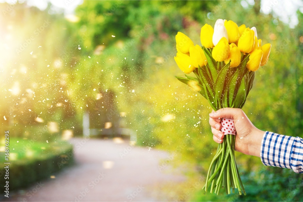 Hand holds flower.