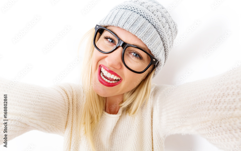 Young woman in winter clothes taking a selfie