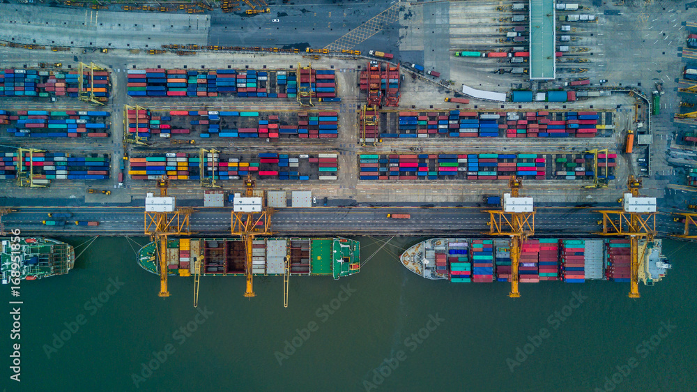 Aerial view of a Cargo vessel operations on harbor, shot from drone,Thailand.