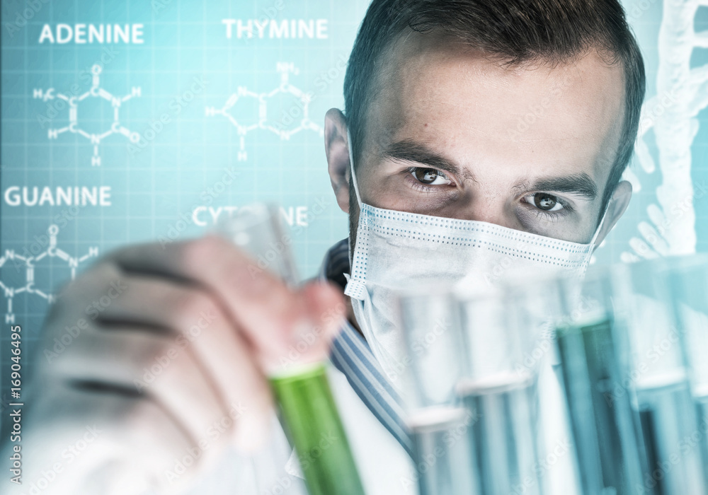 Portrait of concentrated male scientist working with reagents in laboratory