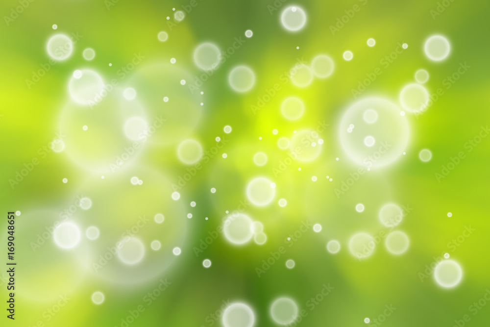 Artistic blurred yellow green colored circle bokeh pattern background.