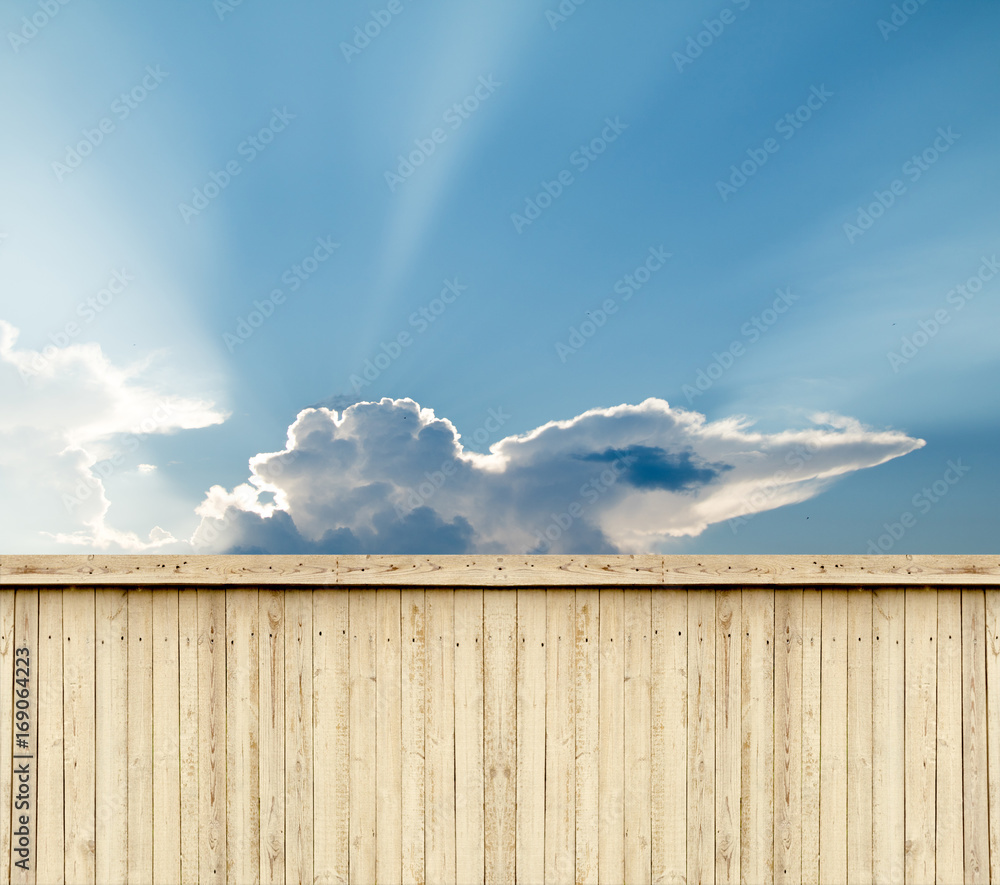 wooden fence sky clouds