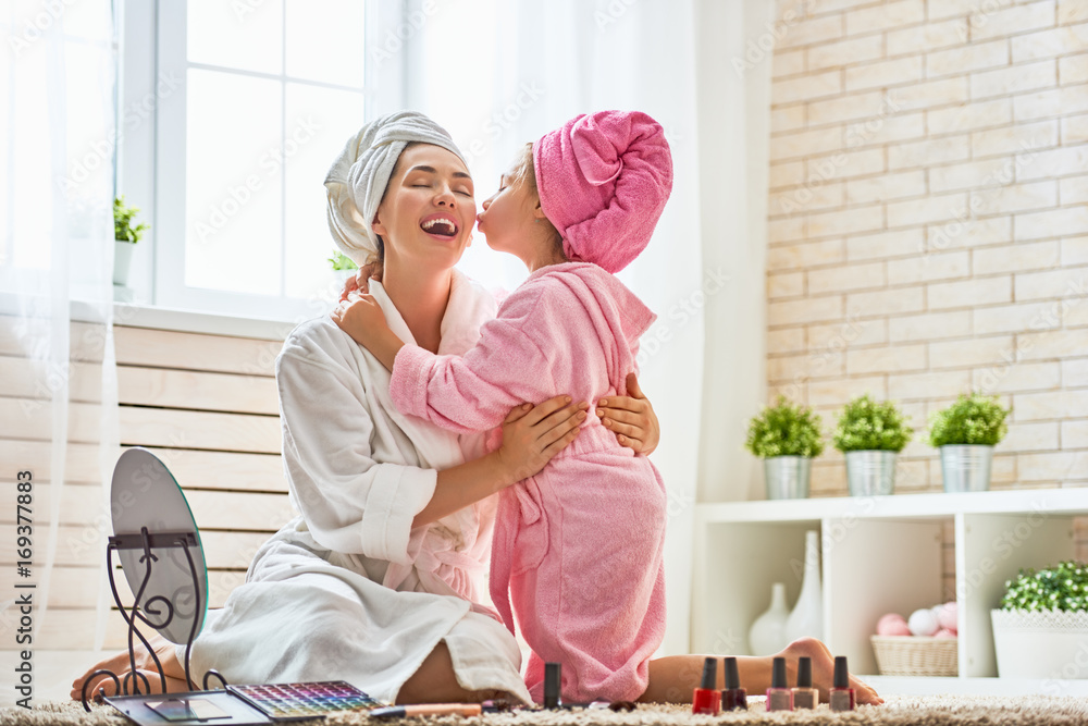 Mother and daughter are doing make up