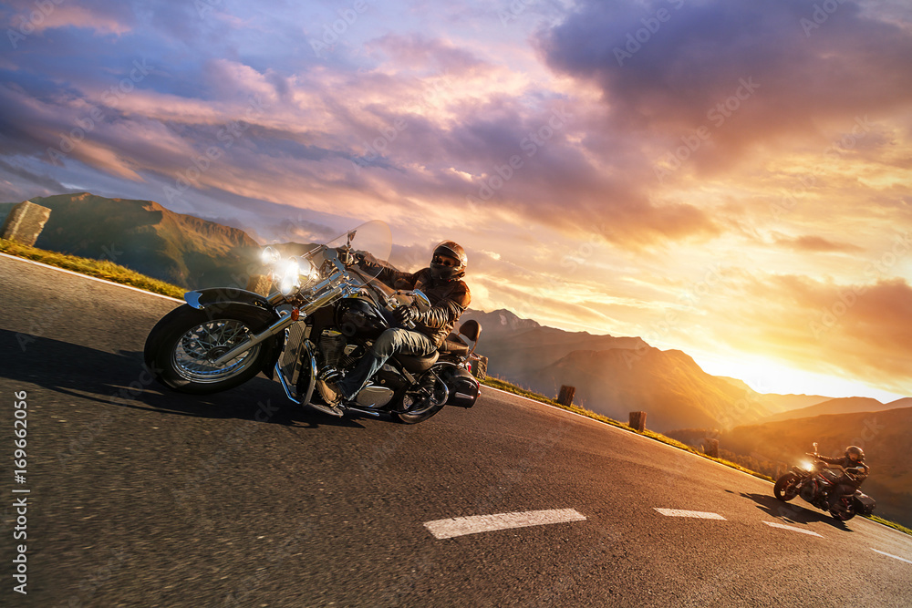 Motorcycle drivers riding in Alpine highway. Outdoor photography, mountain landscape.