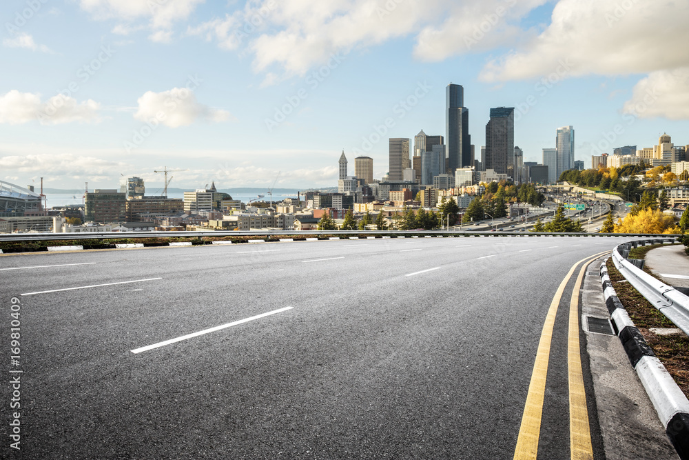 empty road with cityscape of modern city in blue sky