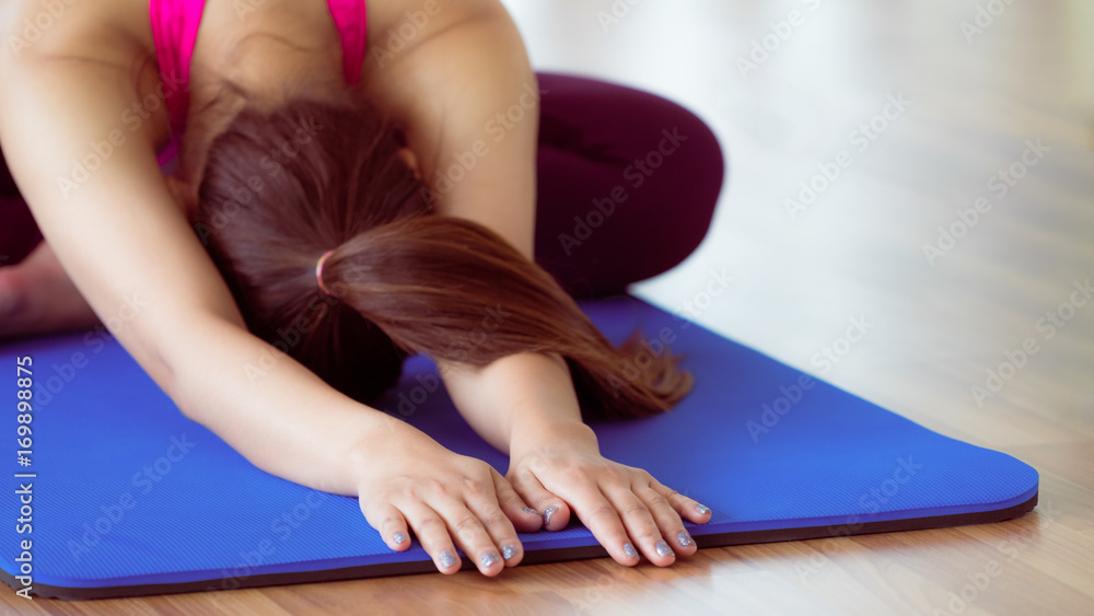 Woman practicing yoga pose in gym