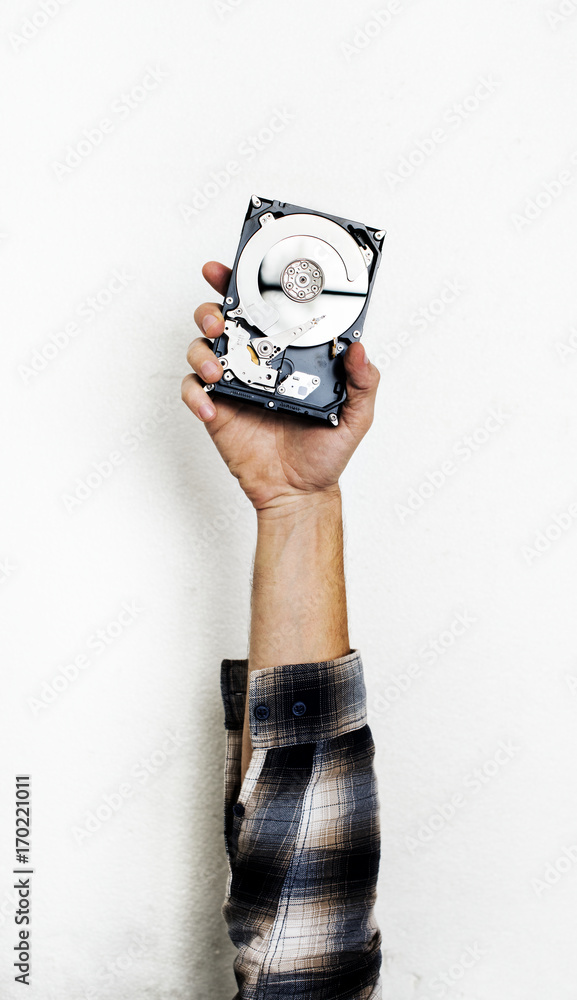 Hand holding computer hard disk drive isolated on white