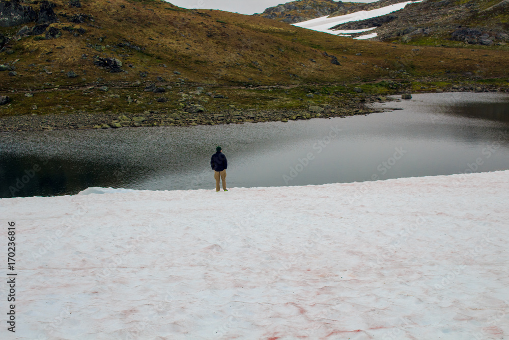 Man looking into the distance on lake in Norway.