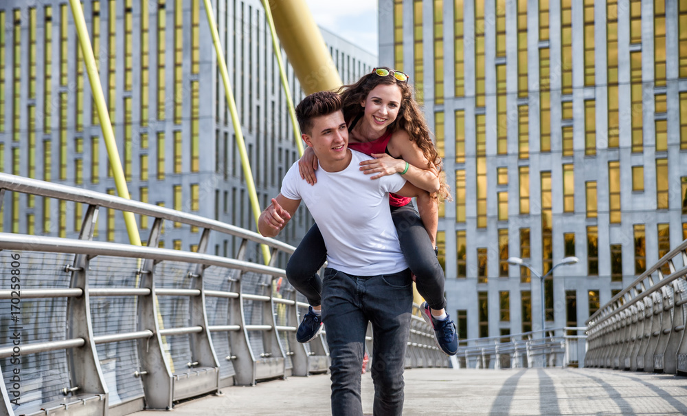 Young couple having fun and walking in the city urban outdoor