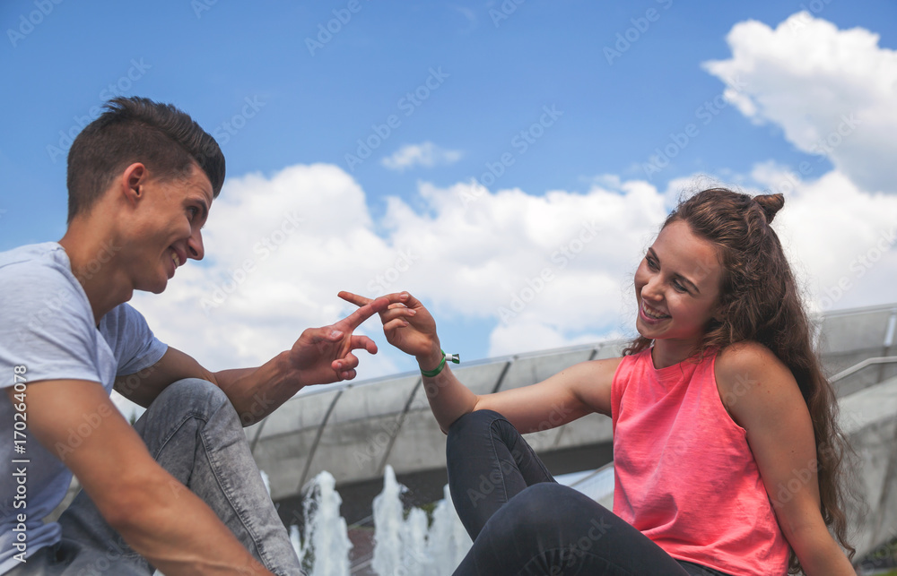 Young couple sitting outdoor and talking, happiness concept