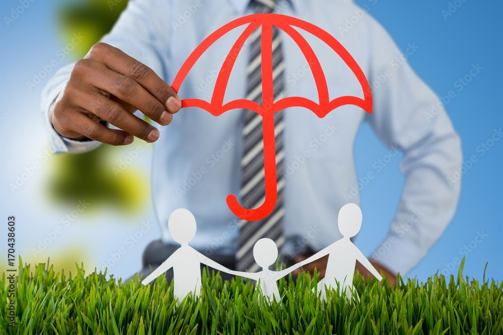 Composite image of family protected by a red umbrella