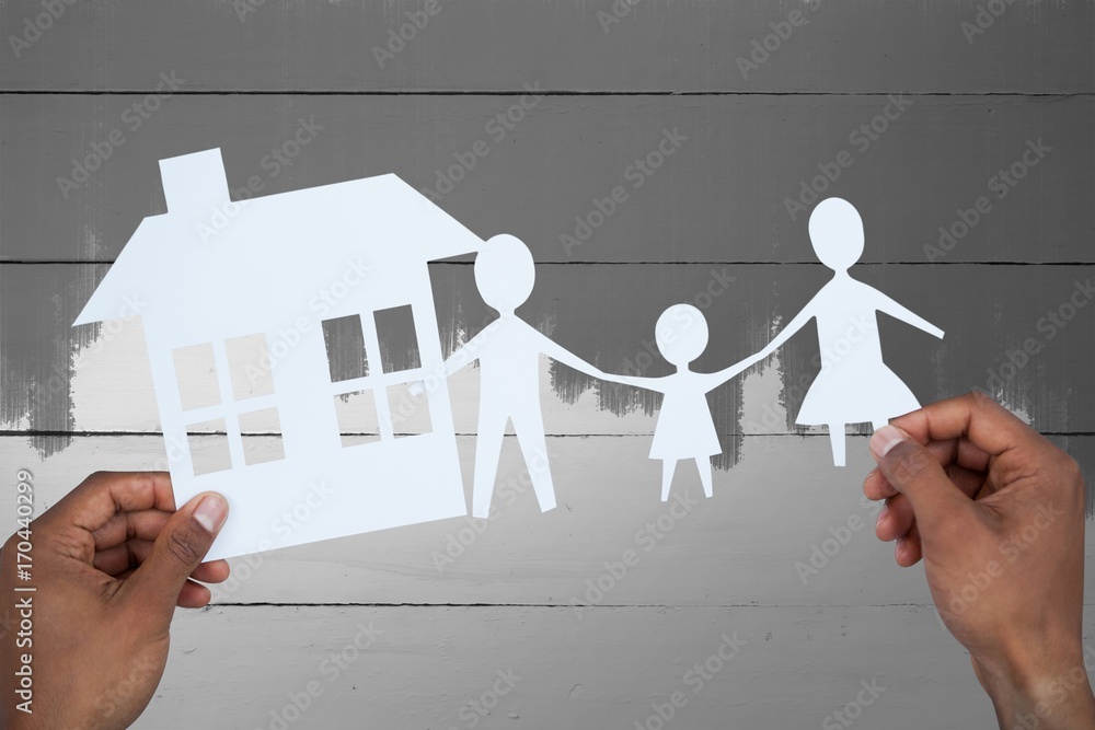 Composite image of hands holding a family with her house in