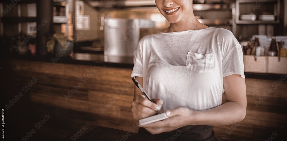 微笑的女服务员站在餐厅里