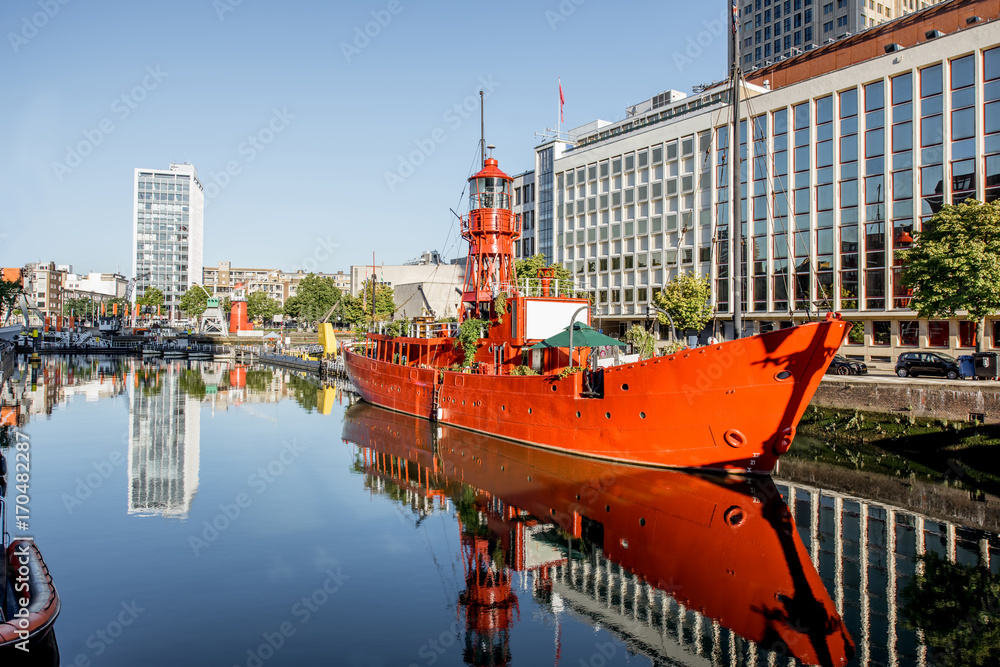 Morning view on the Wijn port with red ship in Rotterdam city