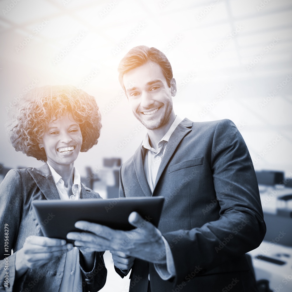 Composite image of business people standing with a tablet