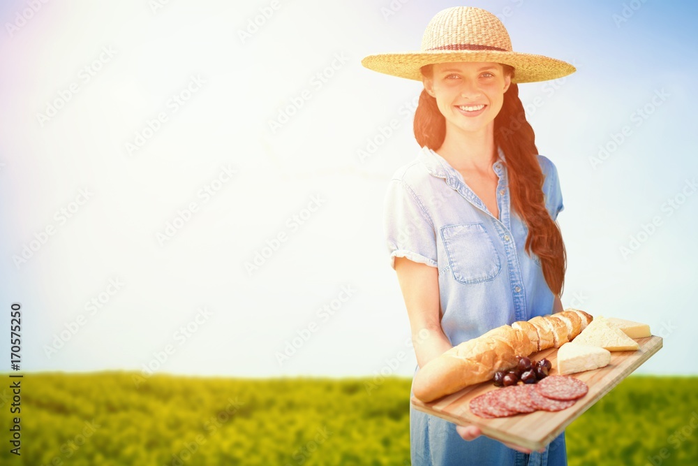 Composite image of smiling woman holding a food tray