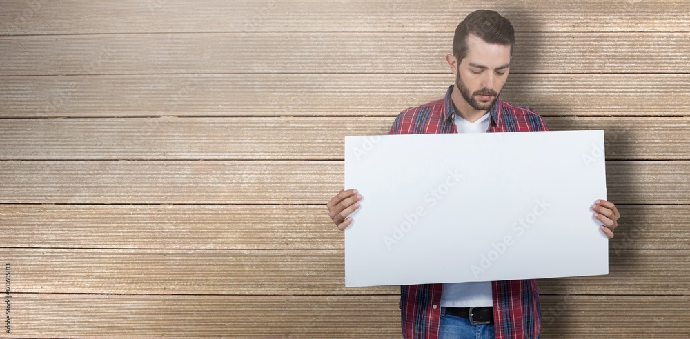 Composite image of male model holding placard