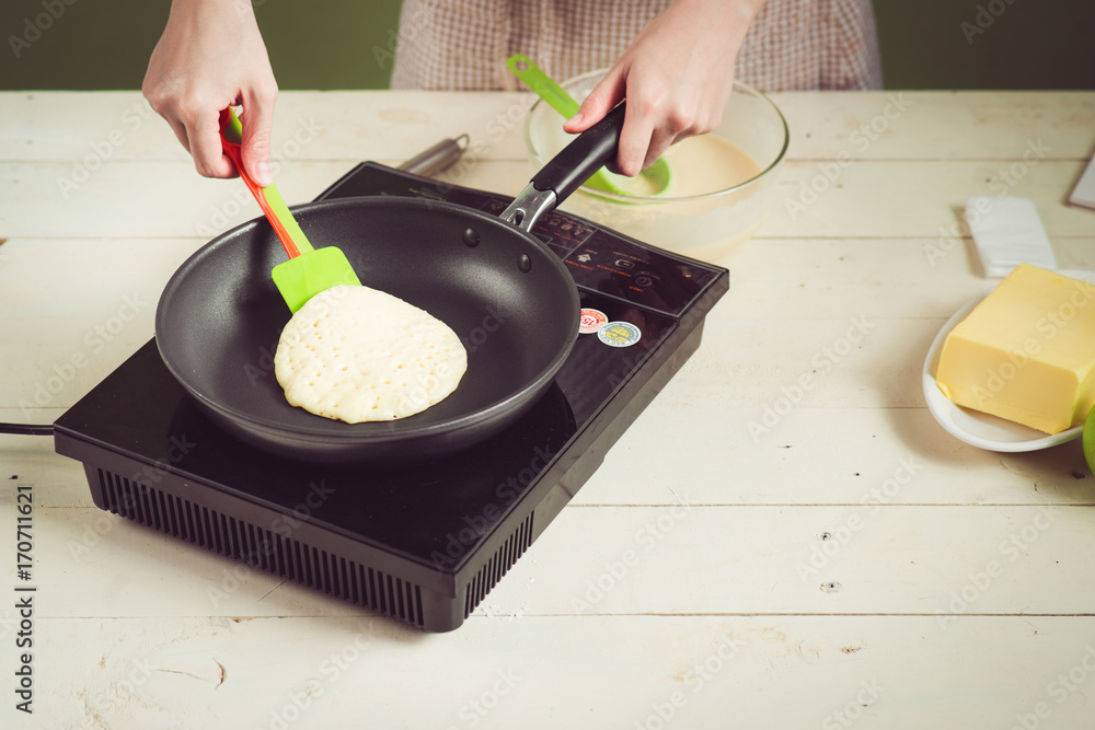 House wife wearing apron making. Steps of making cooking apple cake. Cutting green apple.