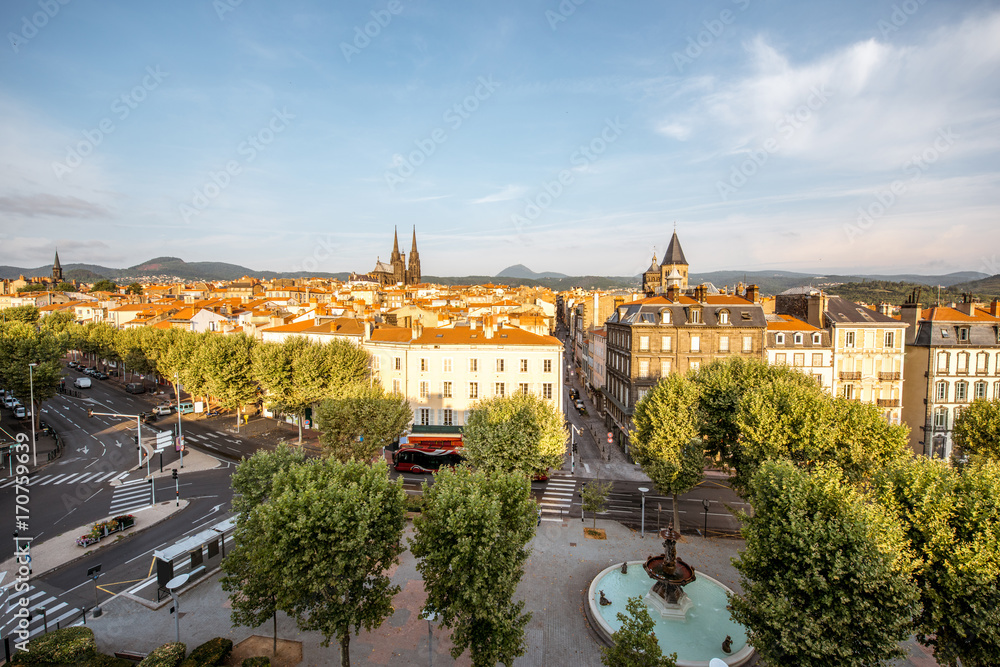 Morning aerial cityscape view on Clermont-Ferrand city with beautiful cathedral and mountains on the