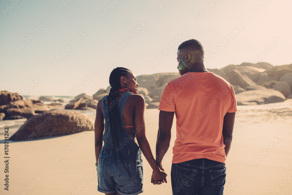 Man and woman in love strolling on the beach