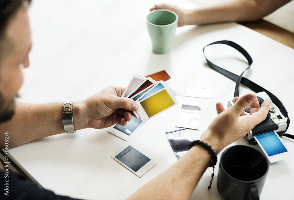 People selecting a photos on the table