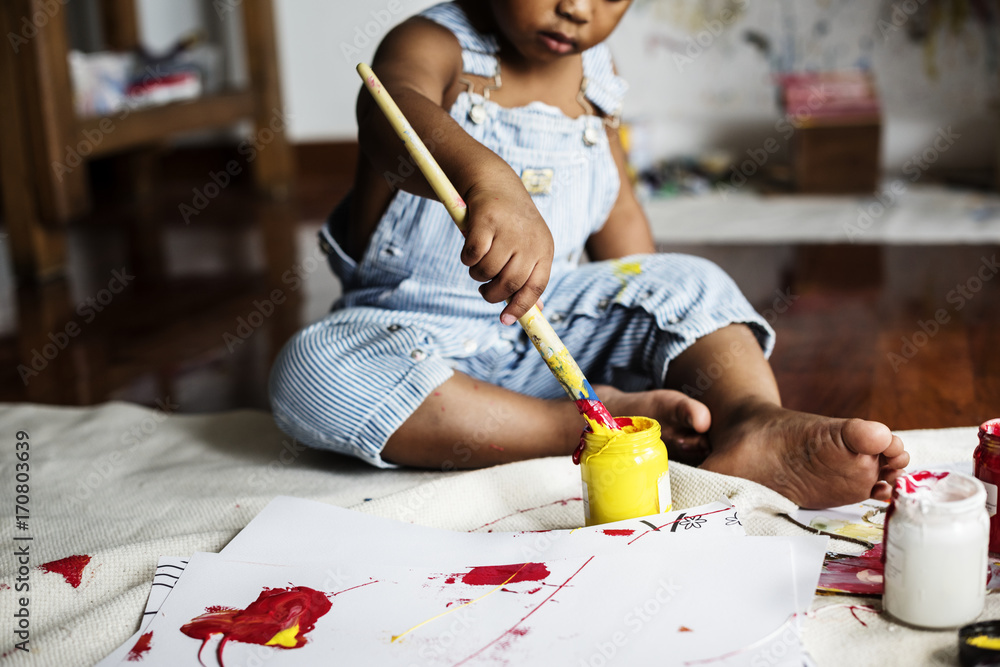 Black kid enjoying his painting