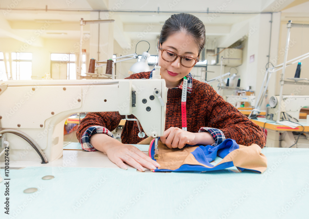 smiling beautiful female fashion studio worker