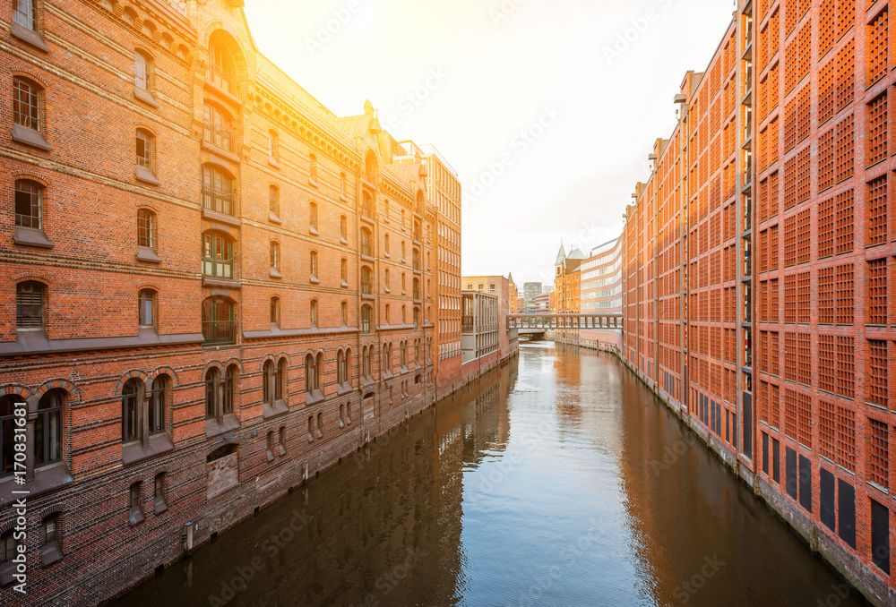 Beautiful view on the water channel with old red warehouses in Hafen district of Hamburg city, Germa