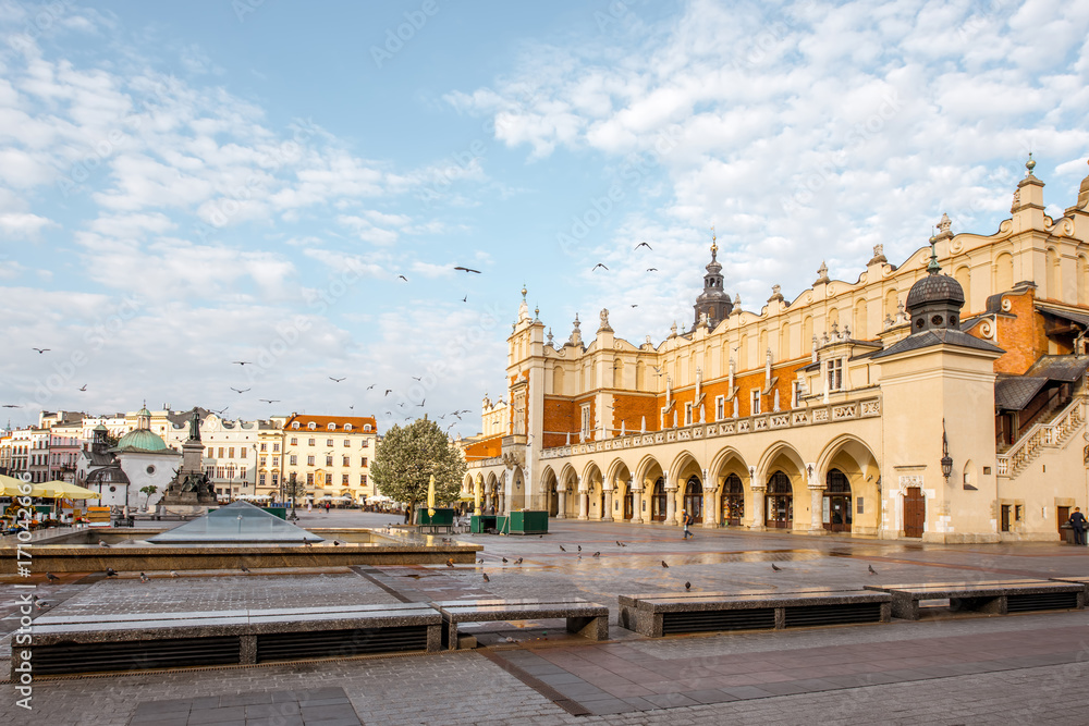 Cityscape view on the Market square with Cloth Hall building during the morning light in Krakow, Pol