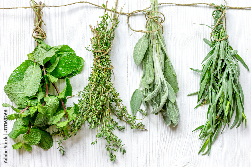 bundles of herbs on wooden background top view