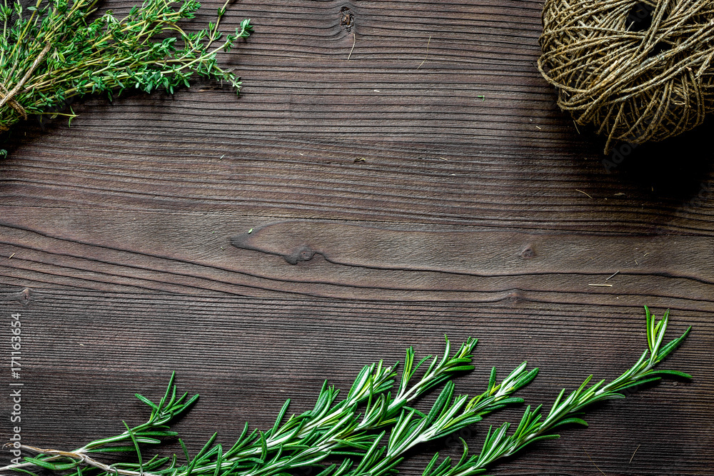 fresh herb frame on dark wooden background top view