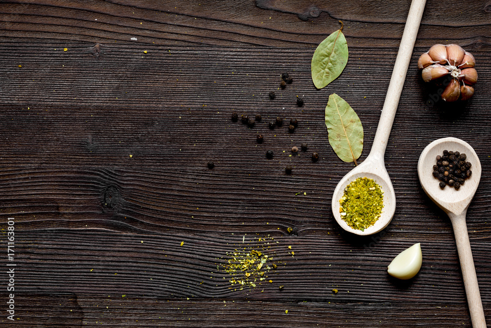 spices in spoon on wooden table top view