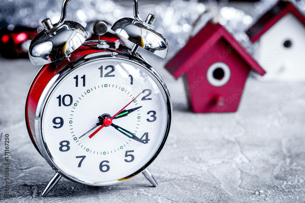 metal alarm clock and tree toys close up