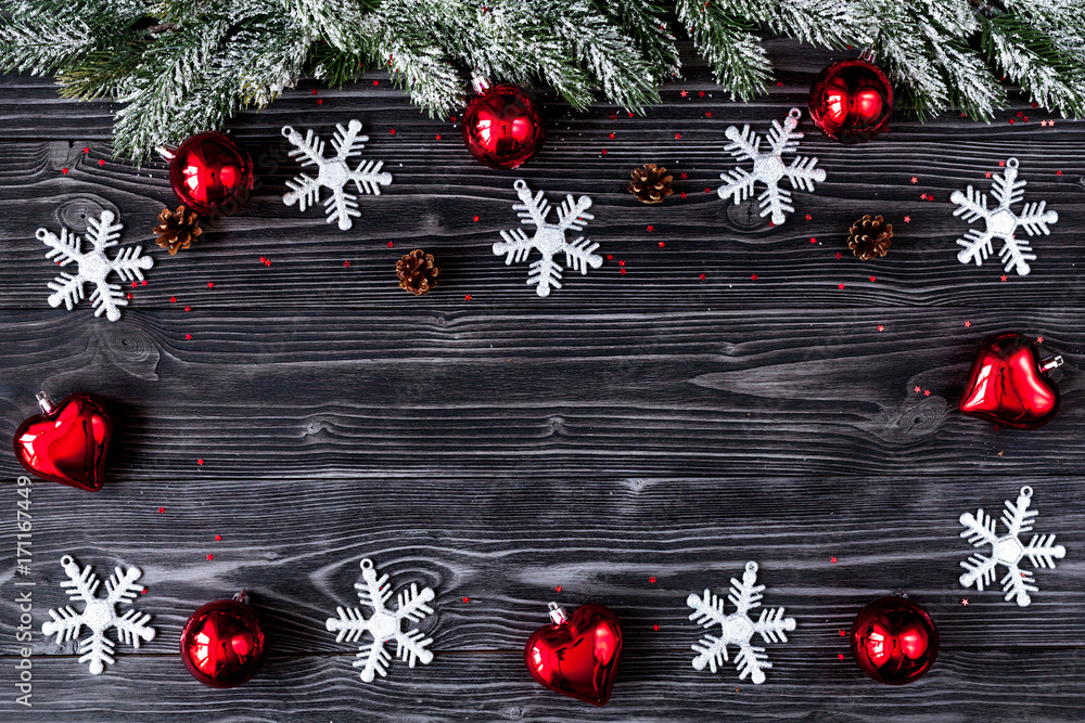 Christmas decorations, spruce branches on dark wooden background