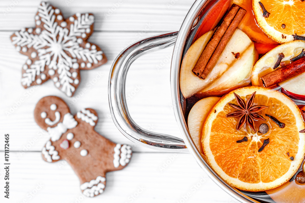 preparation of mulled wine in pot wooden background top view