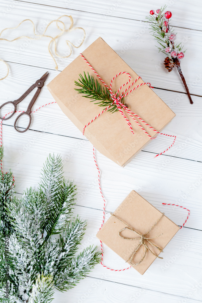 gifts boxes with fir branches on wooden background top view