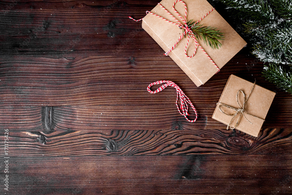 gifts boxes with fir branches on wooden background top view