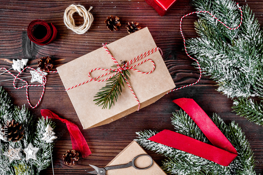 gifts boxes with fir branches on wooden background top view