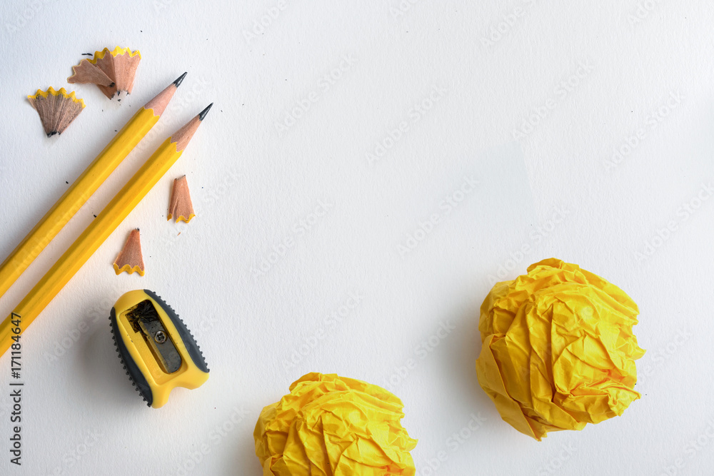 The Yellow pencil and yellow crumpled paper with shaving on white drawing watercolor paper , creativ