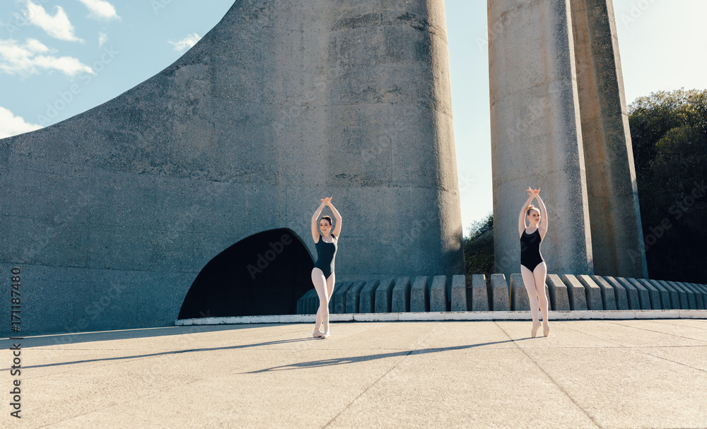 Female ballet dancers practicing duet dance